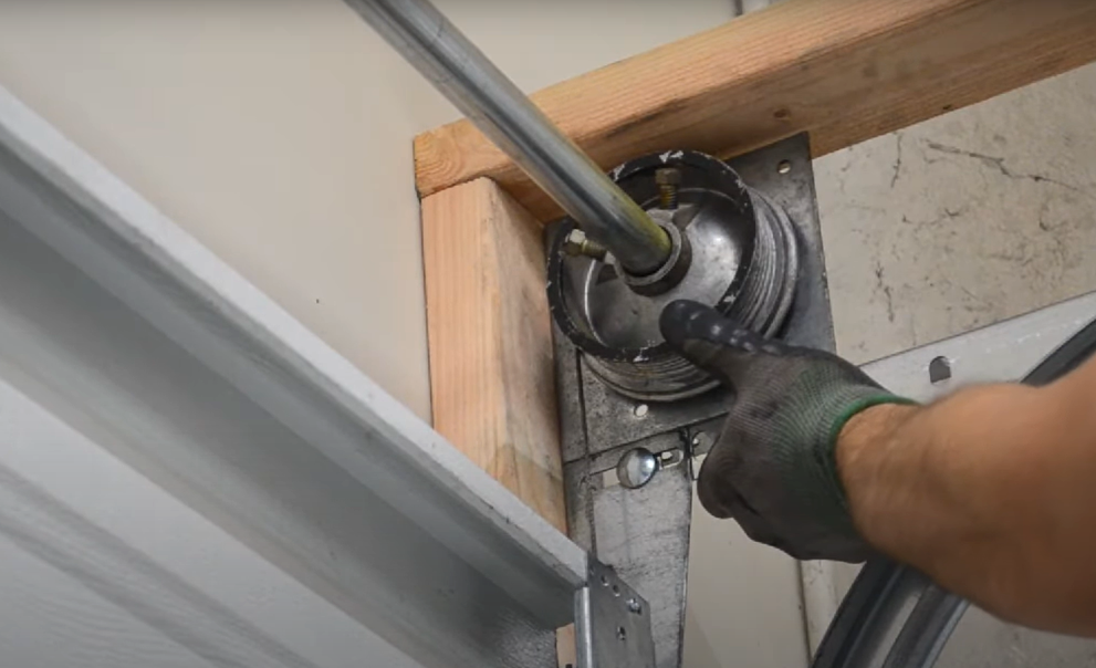 Garage door technician performing cable repair on an overhead garage door to ensure smooth and safe operation