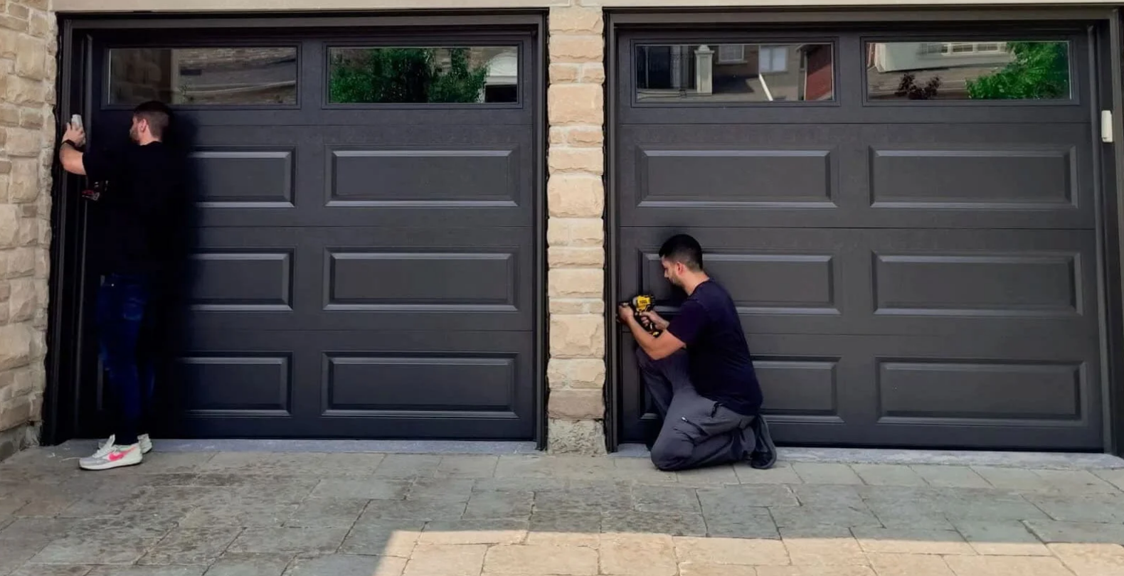 Technician performing garage door panel repair on a residential garage door, ensuring smooth operation and restored appearance