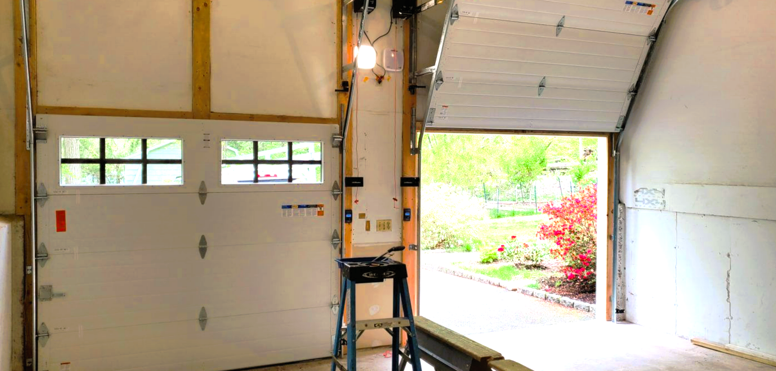 Technician completing a professional garage door installation for a residential home"