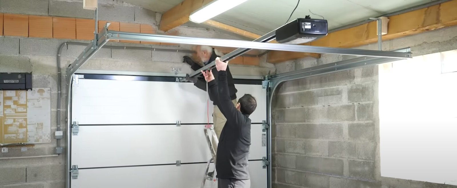 professional technician inspecting a garage door opener system for issues