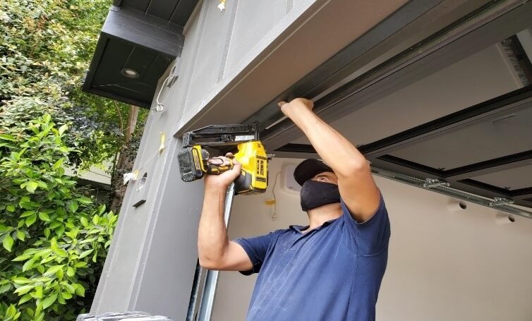 Emergency garage door repair service technician replacing hardware parts in Gahanna Ohio